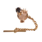 Hand Holding Black Star Sapphire Tie Tack